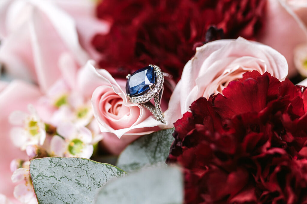 engagement ring on flowers on wedding day for getting ready photographs