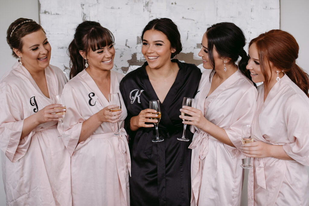 bride with bridesmaids on wedding day for getting ready wedding photographs