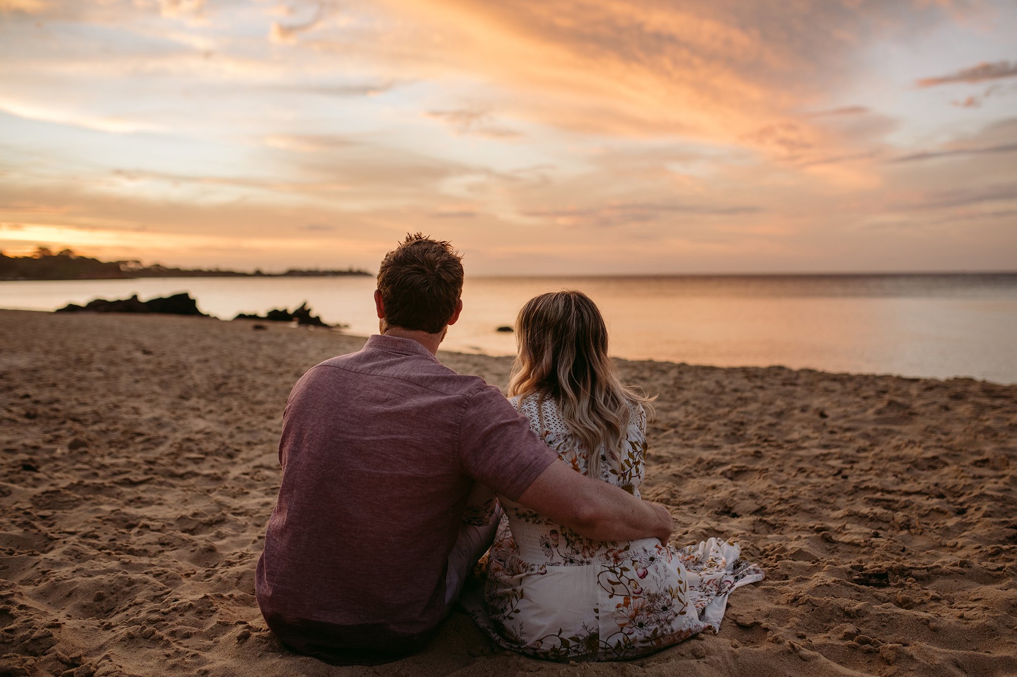 A couple are looking at the sunset at the beach at this Mornington Peninsula Engagement Photo location